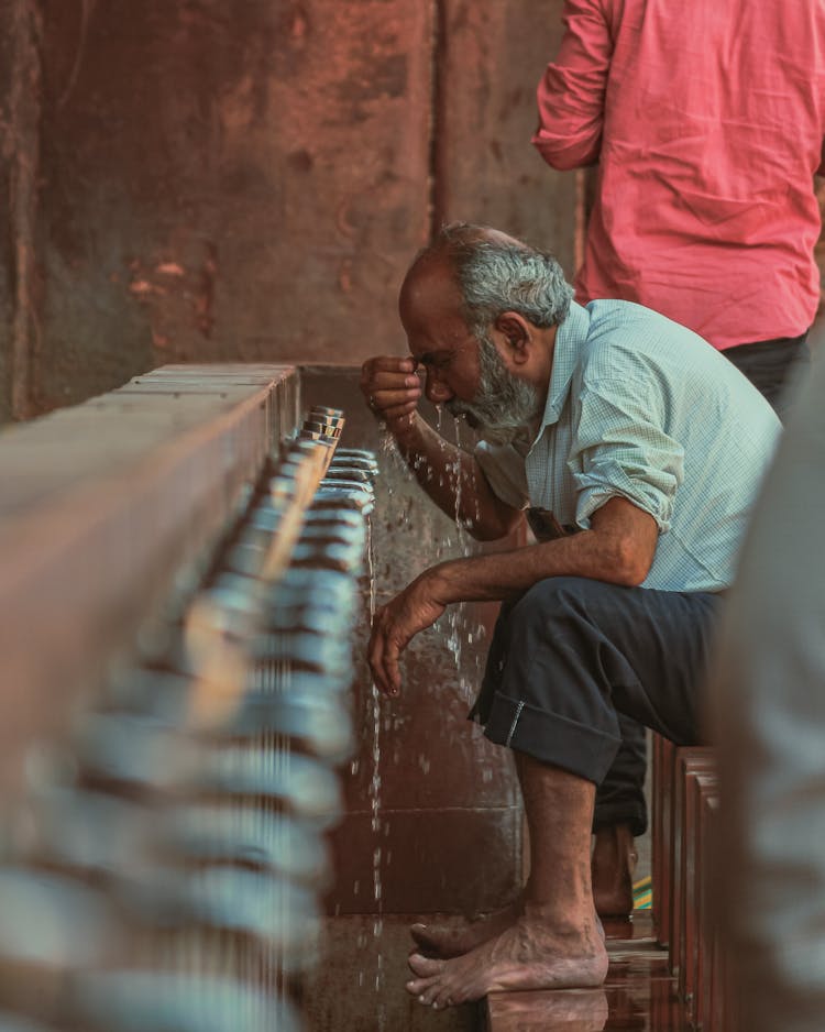 Elderly Man Washing Face With Cold Water