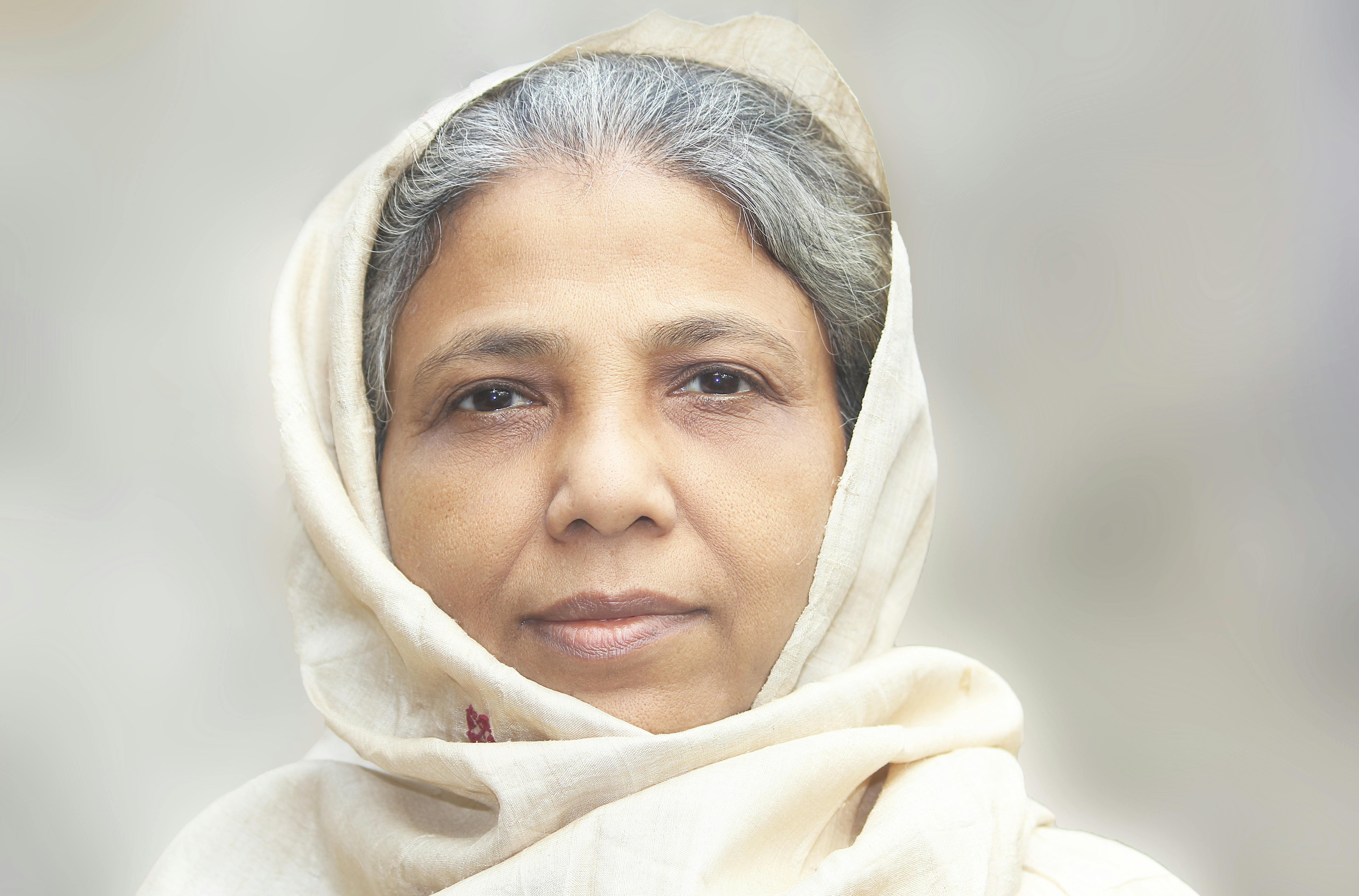portrait of an elderly woman wearing white headscarf