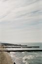 Brown Wooden Dock on Sea Under White Sky