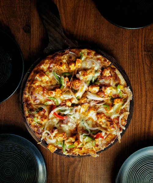 Pizza on Brown Wooden Table