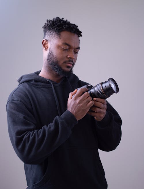 A Man in Black Hoodie Holding a Camera