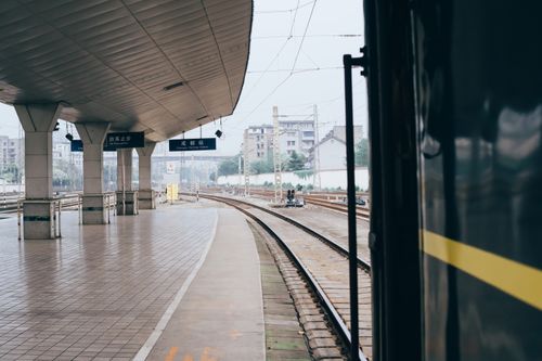 Free An empty train station with curved tracks showcasing modern infrastructure, creating a serene urban scene. Stock Photo