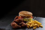 Chicken burger with chicken wings and french fries
