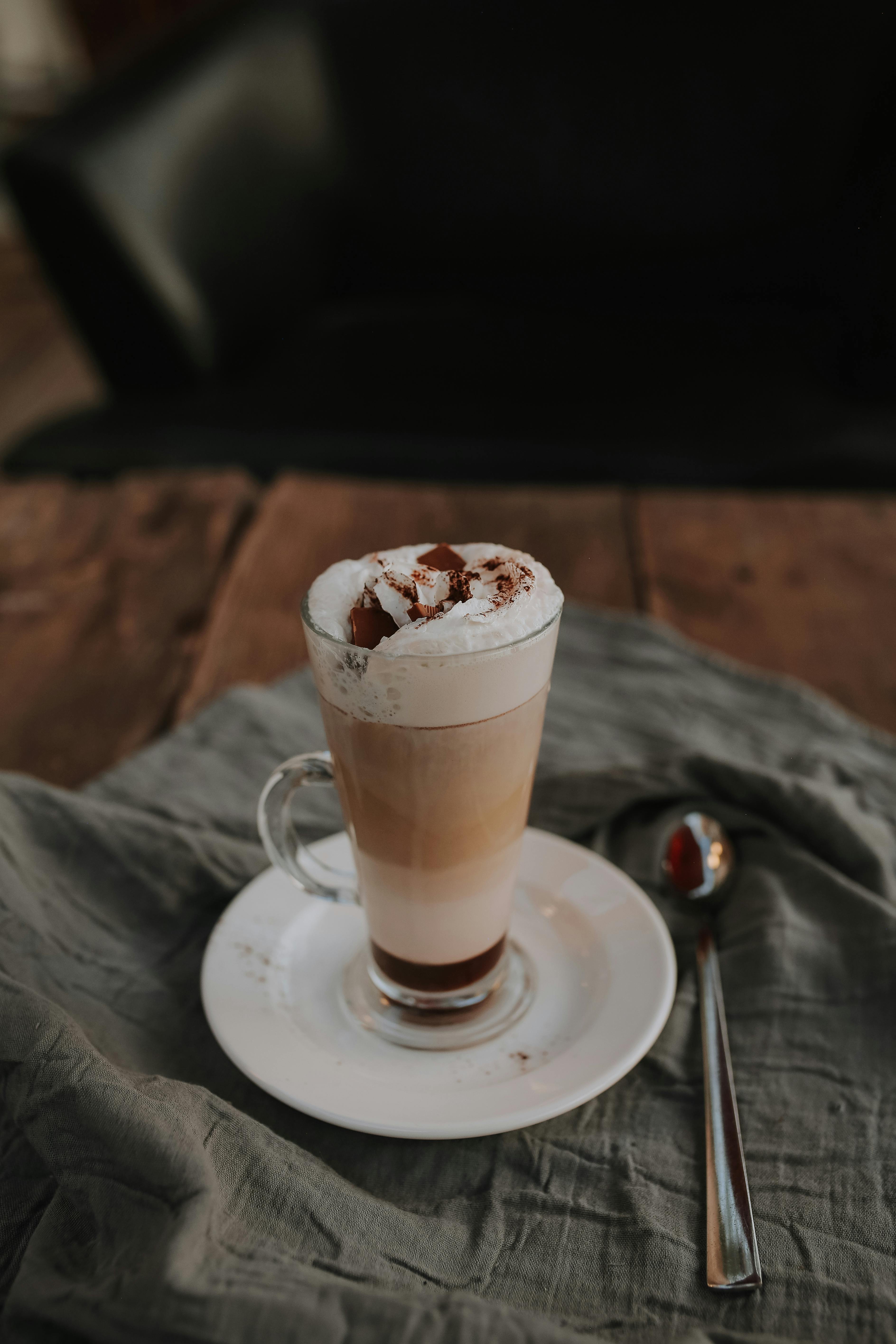 tall glass on latte on wooden table