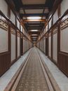 Brown and White Hallway With Brown Wooden Doors
