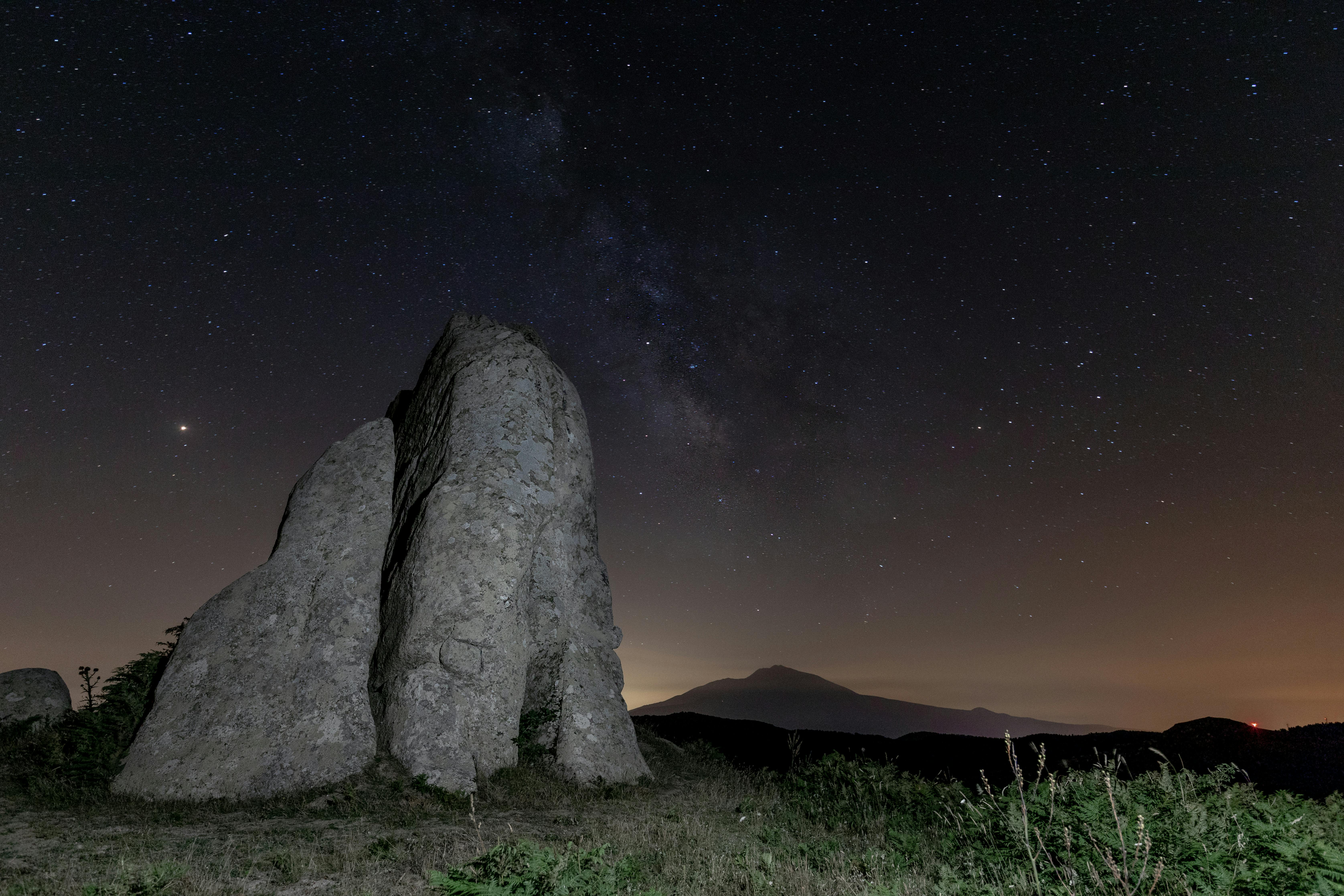 Breathtaking astrophotography featuring stars above a unique geological formation.