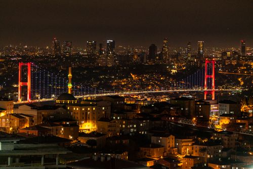 Free Dazzling night view of Istanbul's skyline featuring the Bosphorus Bridge illuminated in vibrant lights. Stock Photo
