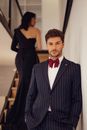 Woman Passing by Man in Suit