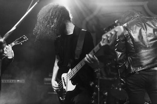 Gray Scale Photo of Man Lifted by People Holding Stratocaster Guitar ...