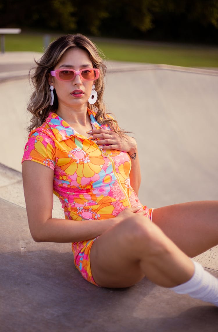 Girl In A Colourful Floral Outfit Posing In A Skatepark 