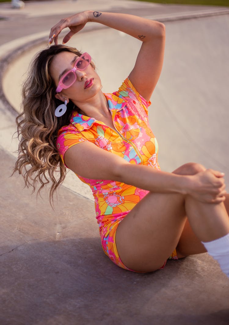 Girl In A Colourful Floral Outfit Posing In A Skatepark 