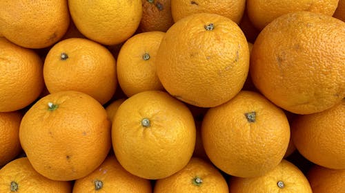 Fresh oranges on fruit market, close up