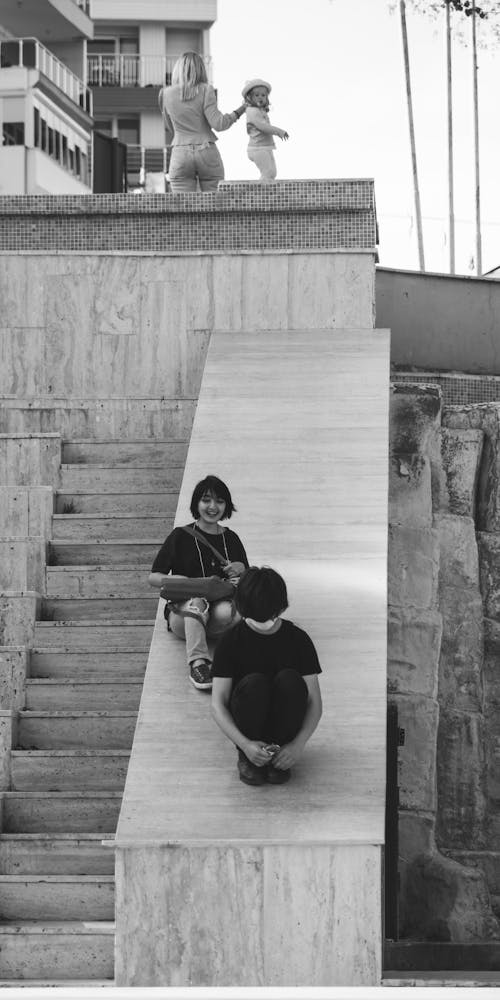 Monochrome Photo of People on a Staircase