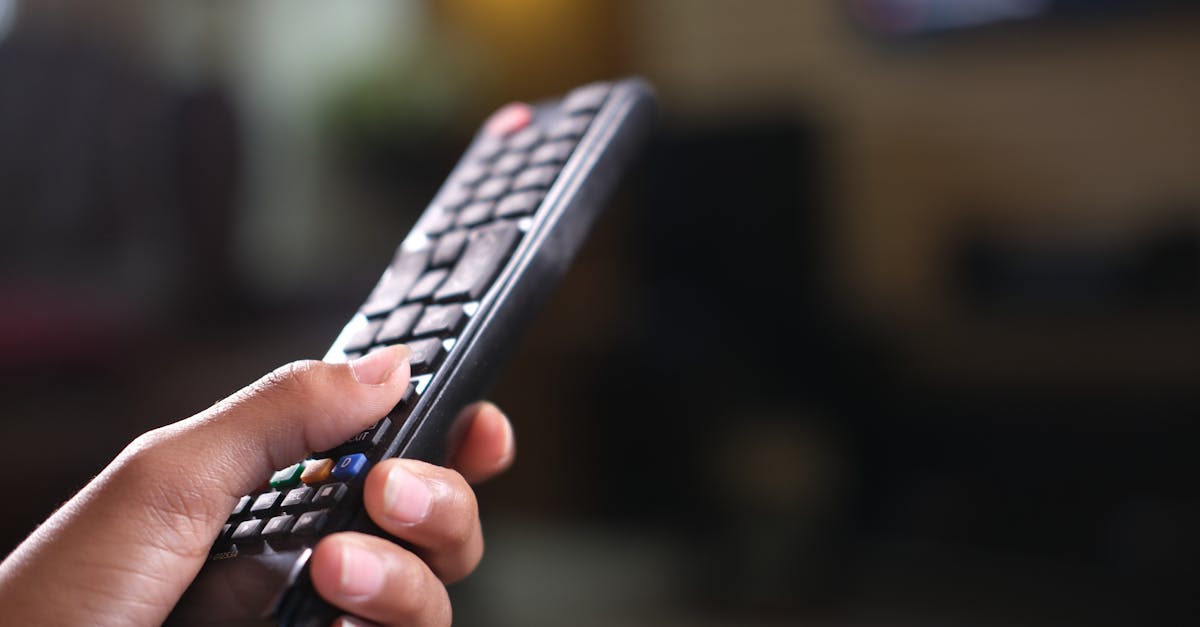 Person Holding Black Remote Control · Free Stock Photo