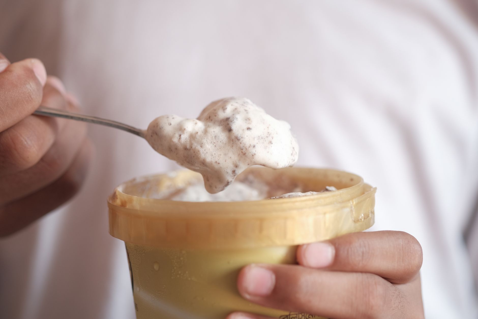 Scooping homemade vanilla ice cream with chocolate chips variation