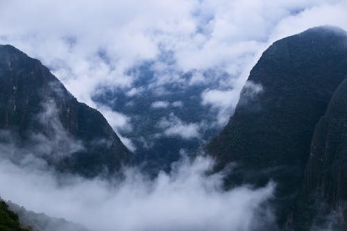 Free Clouds Between Green Mountains  Stock Photo
