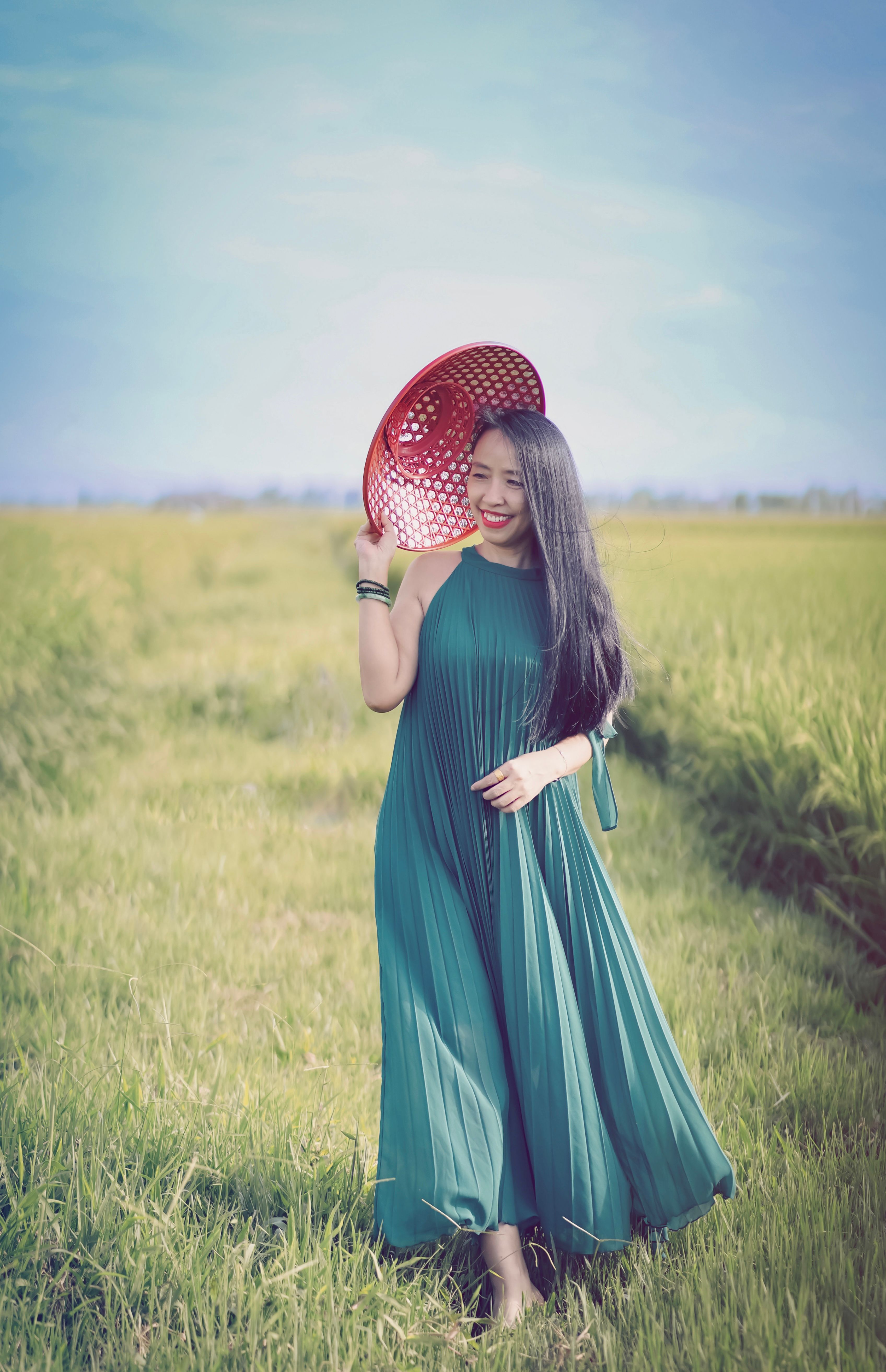 Woman in Blue Dress Standing on Green Grass Field · Free Stock Photo