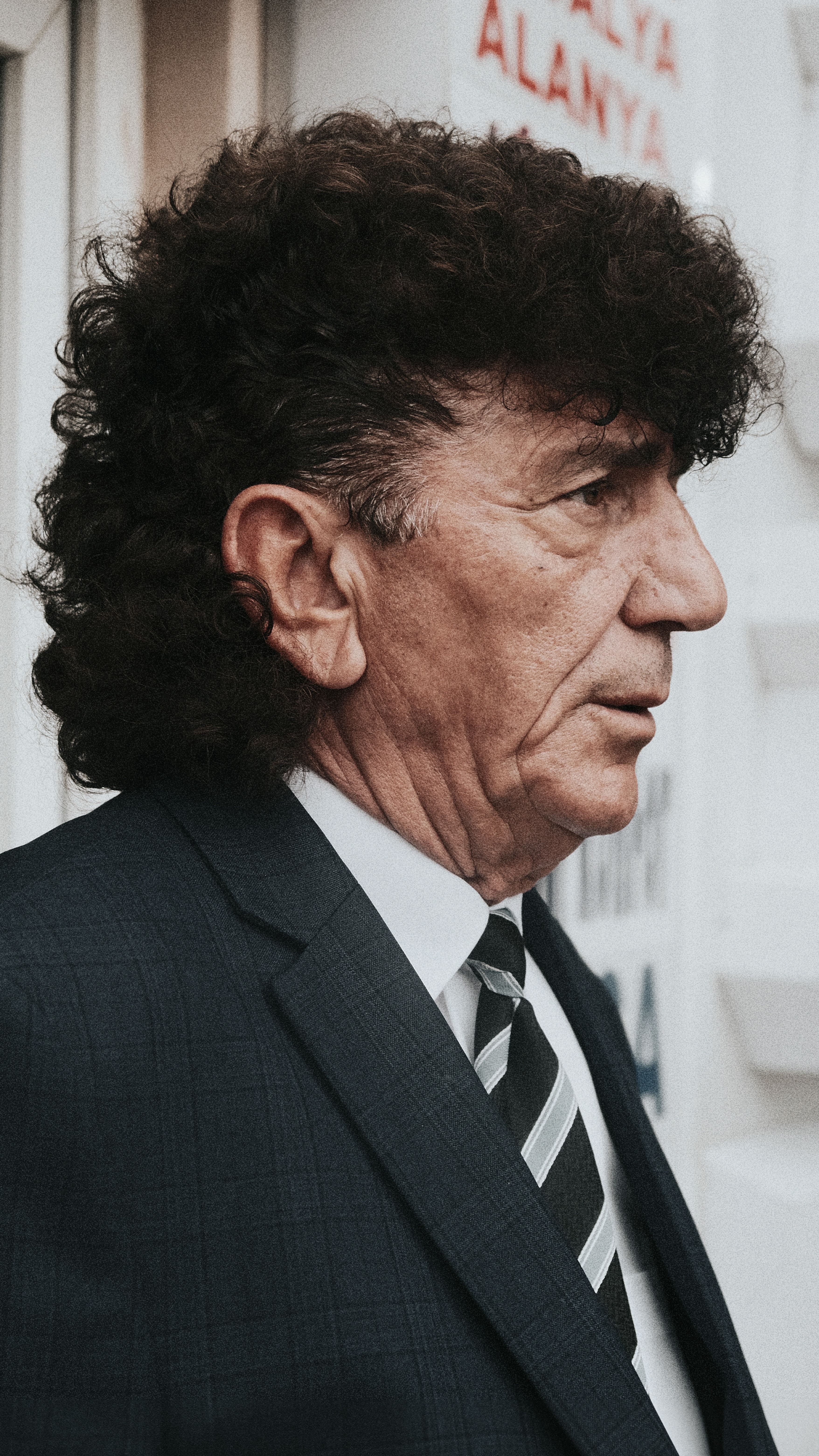 Close-up profile of a senior man with distinctive hairstyle in İstanbul.