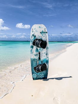 A vibrant wakeboard stands on the pristine sandy beach of Gran Roque, Venezuela.