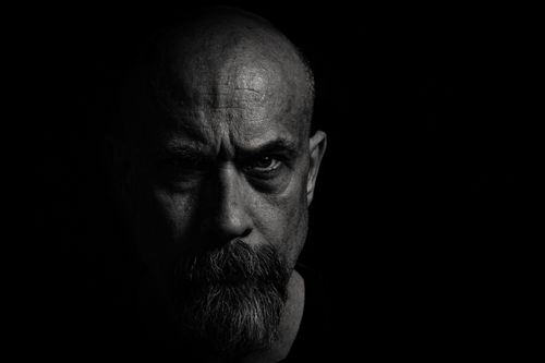 Free A powerful black and white portrait of a bald man with a beard and intense look. Stock Photo