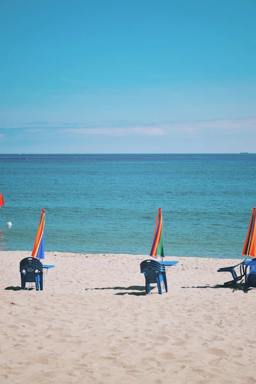 Umbrellas and Chairs on Beachsand 