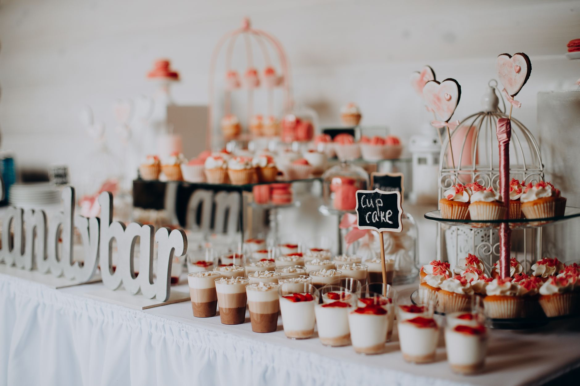 A beautifully decorated dessert table featuring cupcakes and various sweets, perfect for weddings or parties.