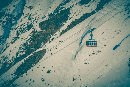 Cable car crossing a snow-covered mountain — photo by Markus Spiske on Pexels