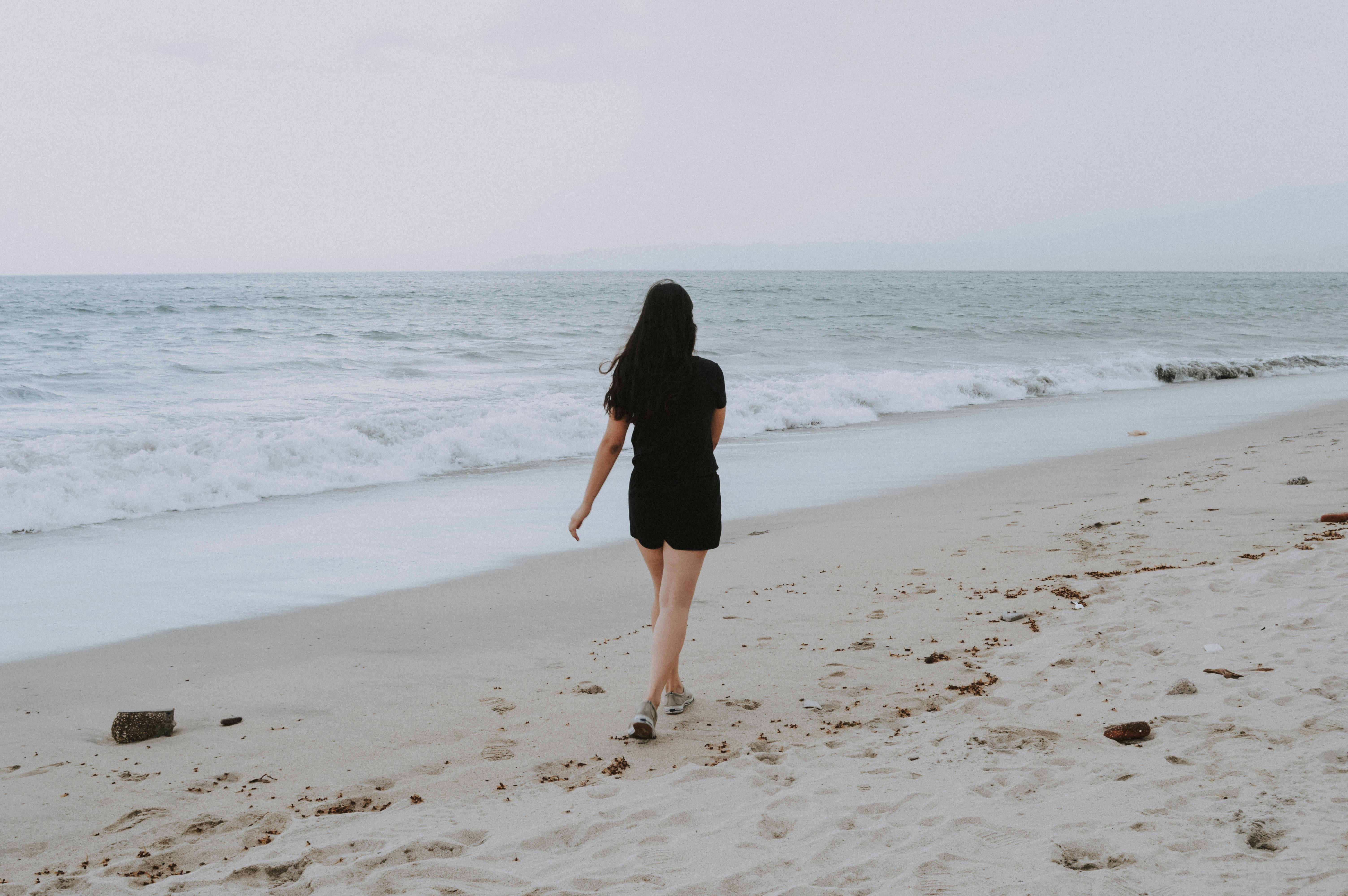 woman standing near body of water