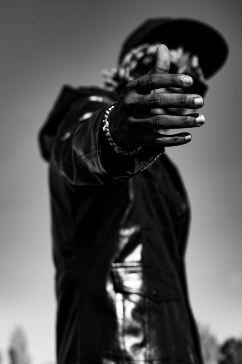 Grayscale Photo of Person in Black Leather Jacket