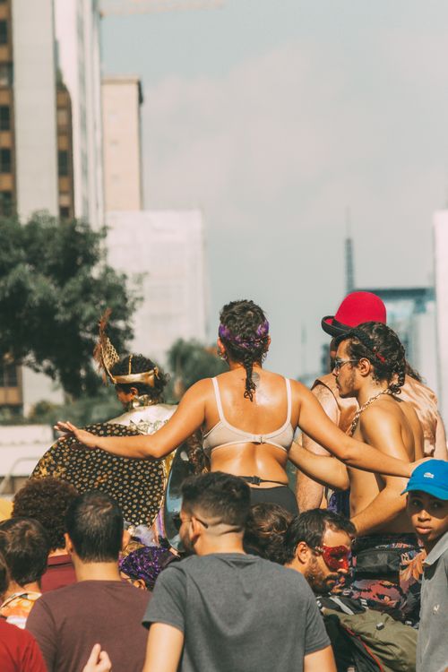 Free Festive gathering of diverse people enjoying an outdoor summer event in vibrant, sunny weather. Stock Photo