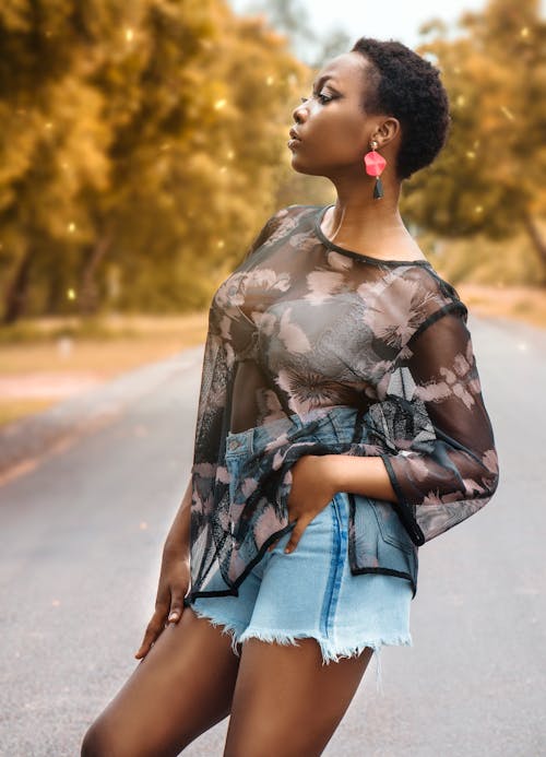 Woman in See Through Long Sleeve Shirt Standing on Road