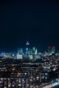 Stunning night view of Rotterdam's dynamic skyline, showcasing modern architecture and city lights.