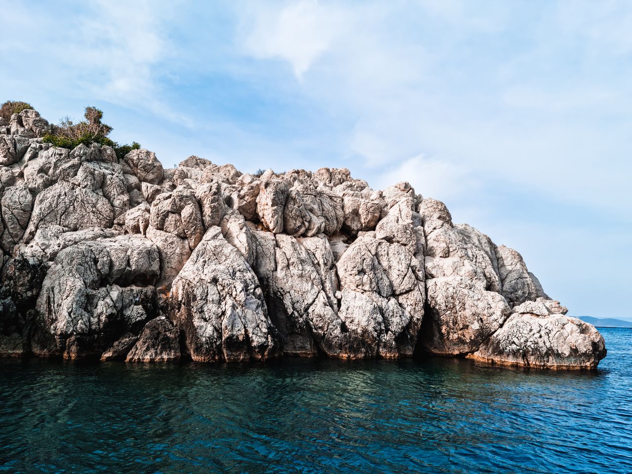 majestic rock formations emerging from the azure aegean sea under a br