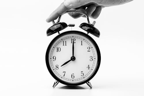 Free Person Touching Black Two-bell Alarm Clock Stock Photo