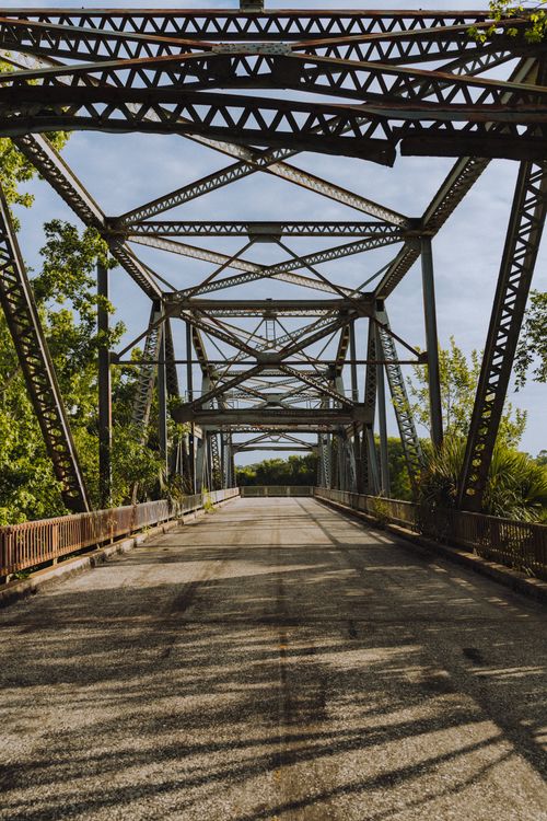 Free An empty steel truss bridge in Sanford, FL, surrounded by lush greenery. Stock Photo