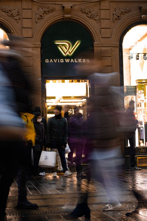 Free Blurry night scene capturing the dynamic pace of an Istanbul street with people walking past a store. Stock Photo