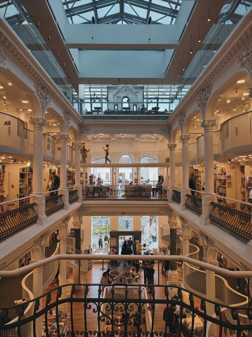 Free A stunning library interior with multiple levels, ornate architecture, and book displays. Stock Photo