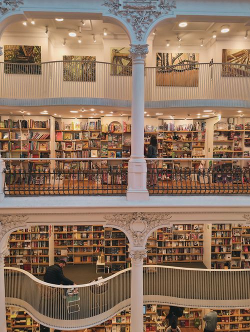 Free A beautiful multi-level library with ornate railings and numerous bookshelves. Stock Photo