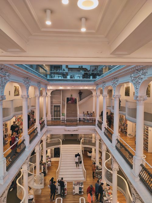 Free Explore the grand architecture and elegant design of a modern bookstore interior with visitors browsing. Stock Photo