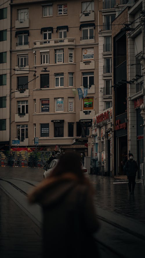 People Walking on Sidewalk Near the Concrete Buildings