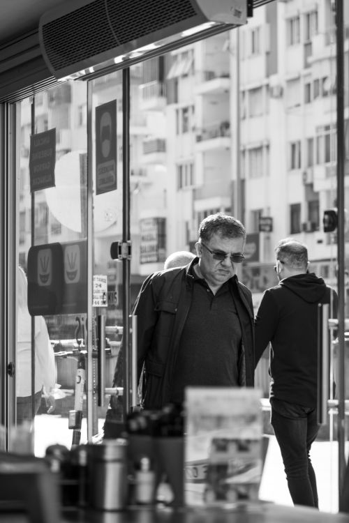 Free Black and white photo of men walking in a city street scene, capturing urban life. Stock Photo