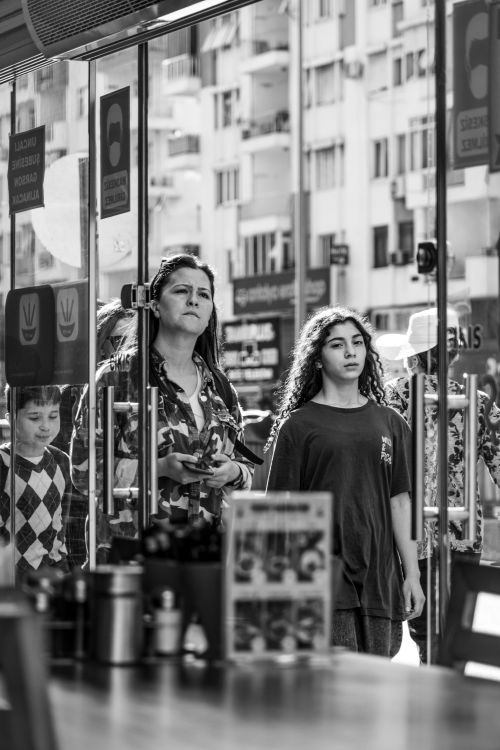 Free Dramatic street scene capturing people walking in an urban setting, in black and white. Stock Photo