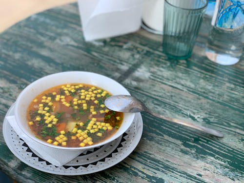 Free A Soup on a Ceramic Bowl with Spoon on the Side Stock Photo