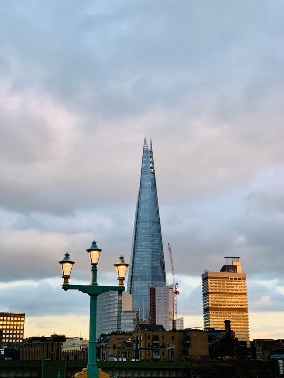 Free A Skyscrapers Under the White Clouds Stock Photo