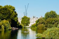 White Concrete Building Near Green Trees and Body of Water