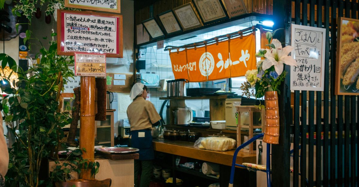 Local street food preparation at a popular stall in Fukuoka
