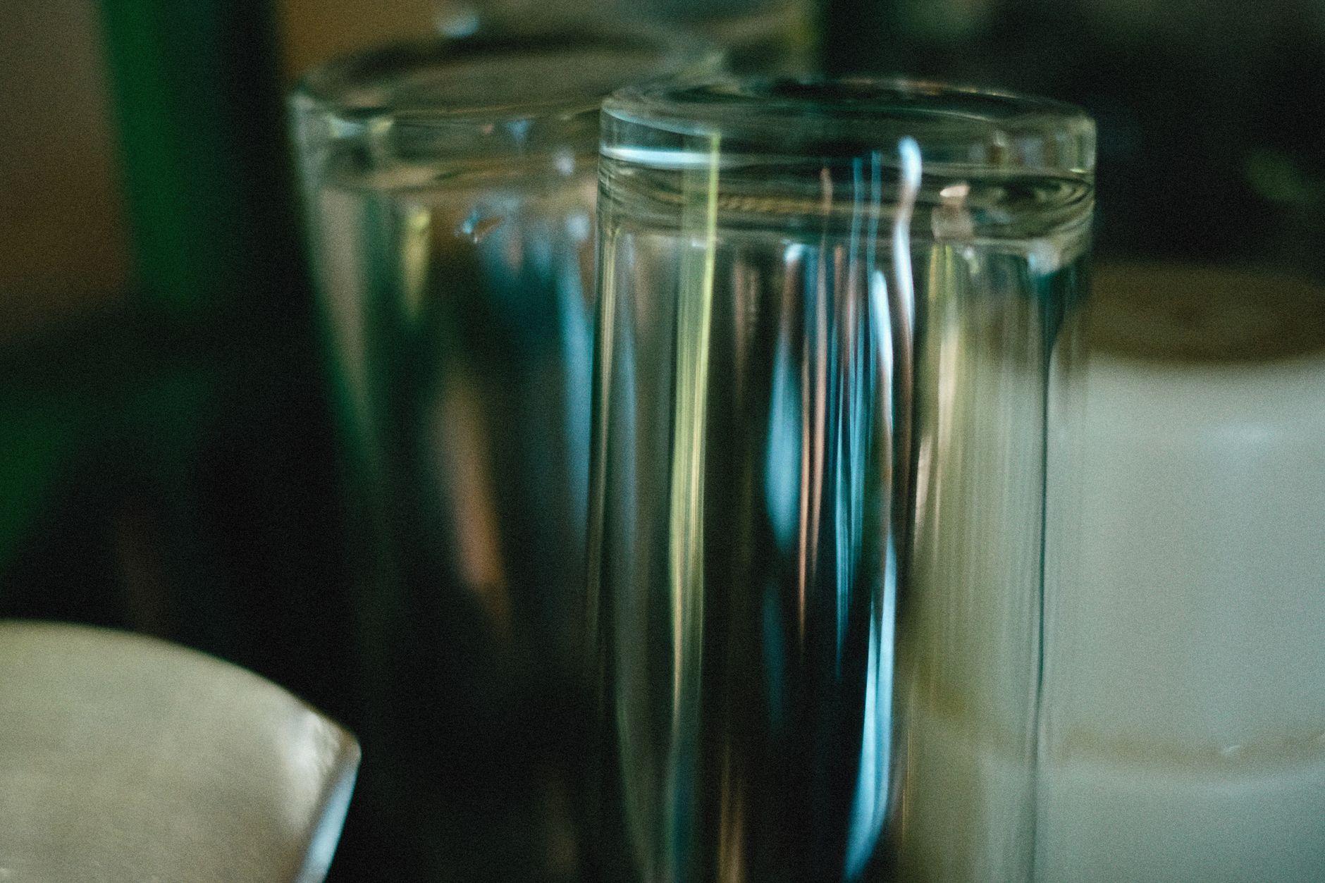 Close-up shot of two glasses with fascinating reflections and blurred background.