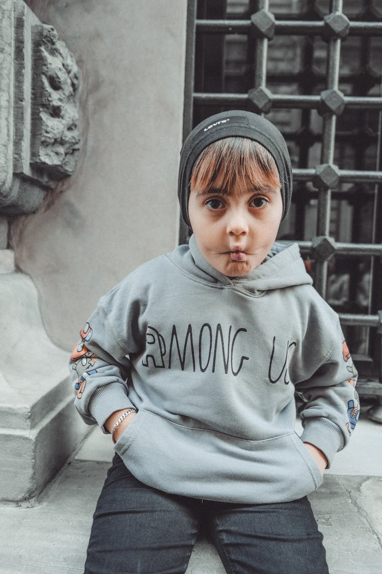 Little Boy In Hoodie Making Faces