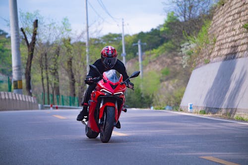 Free A Man in Red Motorcycle Wearing a Helmet Stock Photo