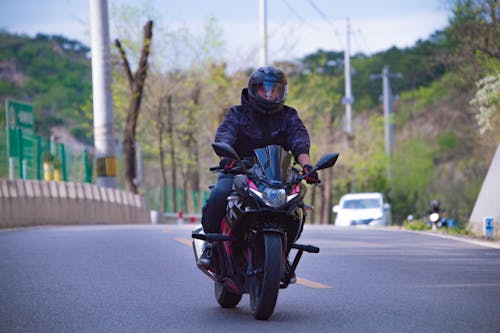 Free Man wearing a Helmet riding a Motorbike Stock Photo